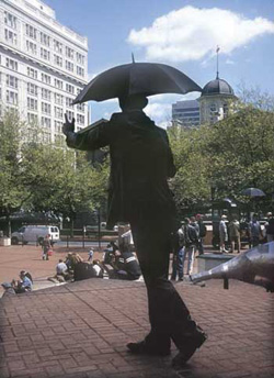 The "commuter with umbrella" statue stands at Pioneer Courthouse Square downtown.